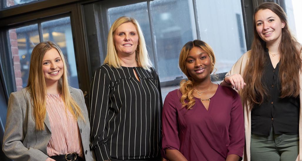 Four students pose in front of window at YouTube Space in NYC